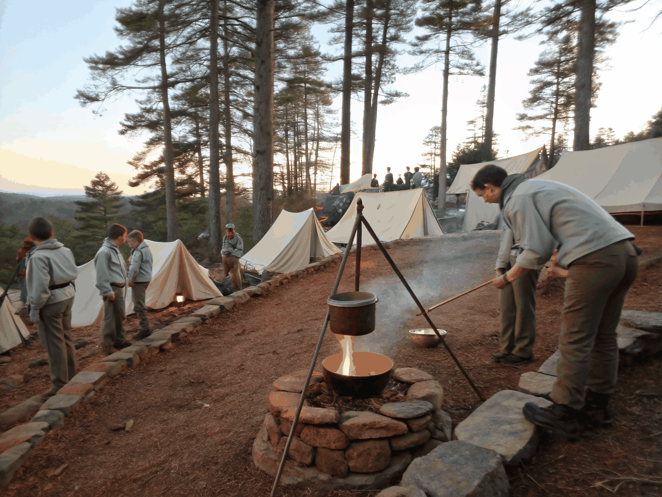 Troop scouts gathered around a warm wood stove in a rustic winter camp cabin